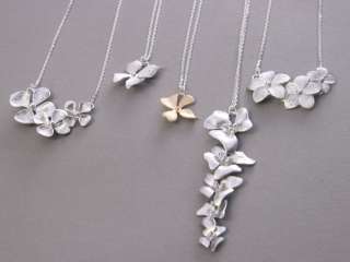 Cascading orchid flowers feature white gold plated . Chain and clasp 