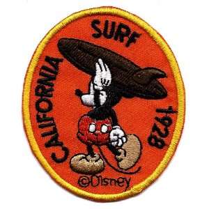 Mickey Mouse California Surf holding surfboard over shoulders at beach 