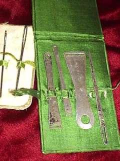 This is a group of 6 needles with two silk cases